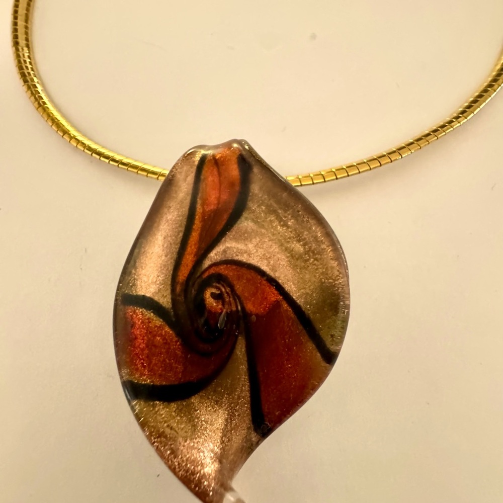 Stunning slide gold with red and black swirls glass and resin slide on necklace.